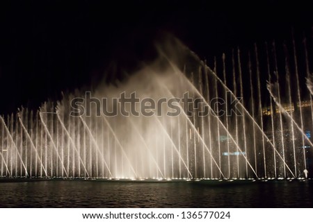 DUBAI, UAE - NOVEMBER 13: Night view Dancing fountains downtown and in a man-made lake in Dubai, UAE on November 13, 2012. The Dubai Dancing fountains are world\'s largest fountains with height 150 m.