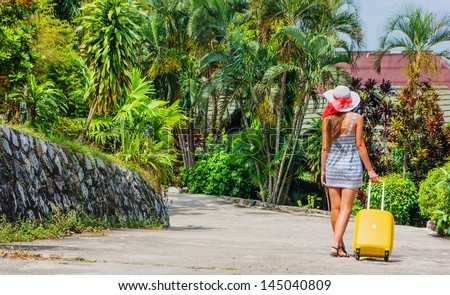 Young girl with a bag goes on the road