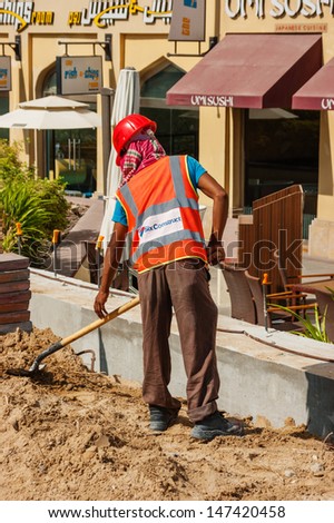 DUBAI, UAE - NOVEMBER 16: Male construction worker in Dubai Marina, on November 16, 2012, Dubai, UAE. Dubai was the fastest developing city in the world between 2002 and 2008.