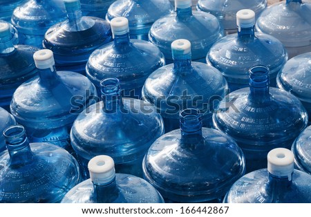 big empty water bottles in a row