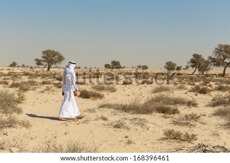 Arab man in national dress in the desert of Dubai