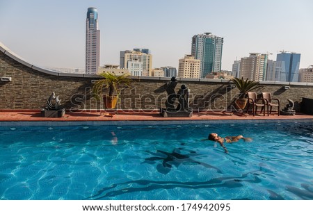 SHARJAH, UAE - OCTOBER 29, 2013: Rooftop pool Royal Grand Suite Hotel. Hotel has 136 guestrooms. Guests can use the in-room complimentary wireless high-speed Internet access