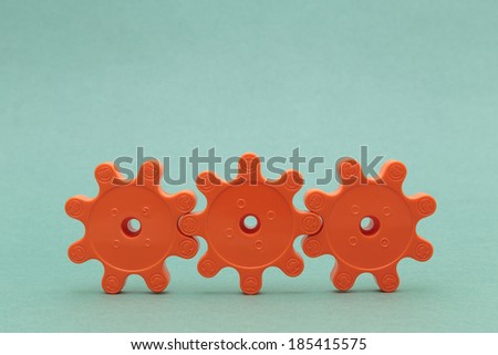 three red plastic gears