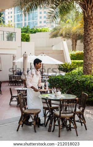 DUBAI, UAE - 16 NOVEMBER, 2012: Waiter in Cafe in Dubai hotel, UAE