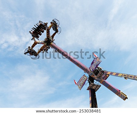 MONTE CARLO, MONACO - NOVEMBER 2, 2014: People wait up in the blue sky for the vertical ride and the zero gravity thrill at an amusement park