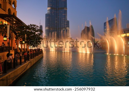 DUBAI, UAE - OCTOBER 31: Night view Dancing fountains downtown and in a man-made lake in Dubai, UAE on November 13, 2013. The Dubai Dancing fountains are world\'s largest fountains with height 150 m.