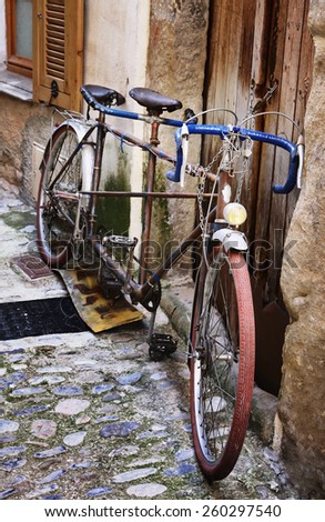Old bicycle on a medieval street in France