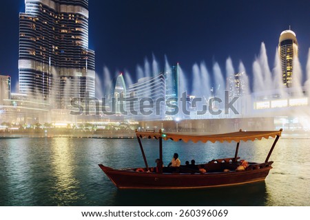 DUBAI, UAE - NOVEMBER 13: Night view Dancing fountains downtown and in a man-made lake in Dubai, UAE on November 13, 2013. The Dubai Dancing fountains are world\'s largest fountains with height 150 m.