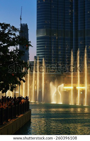DUBAI, UAE - OCTOBER 31, 2013: Fountain in the lake near Dubai Mall. Lake - 6600 lights and 25 projectors, it shoots water 150 m into the air.