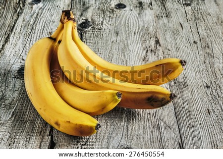 Ripe yellow bananas on old wooden boards
