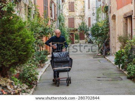 NICE, FRANCE - OCTOBER 30, 2014: The postman delivers mail on the street
