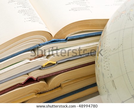 stack of open books and Globe  isolated on a white background