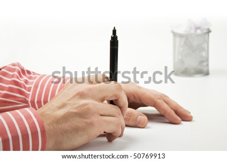 man\'s hand holding a black marker
