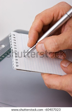notebook and pen in hand