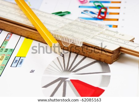slide rule and working paper with a diagram