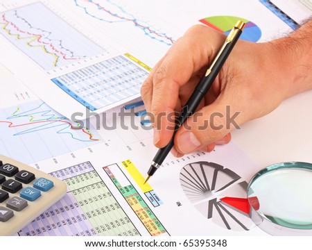pen in hand and working paper chart