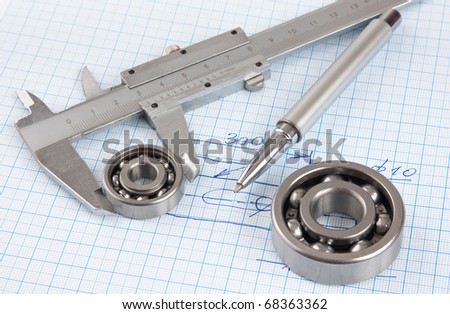 Technical drawing and callipers with  bearing on graph paper