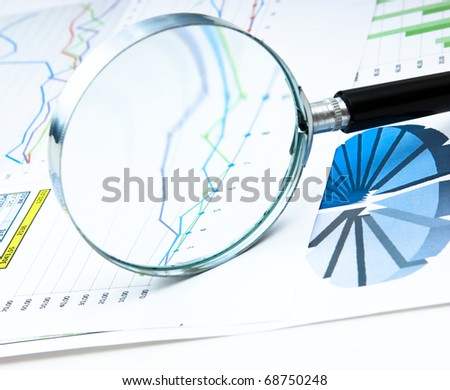 magnifying glass and the working paper with a diagram