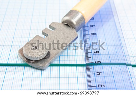 glass cutter and  ruler on the glass