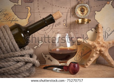 bottle and  glass of wine on background of old maps