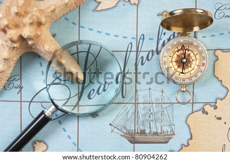 magnifier and compass on a stylized map