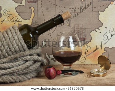 bottle and  glass of wine on background of old maps