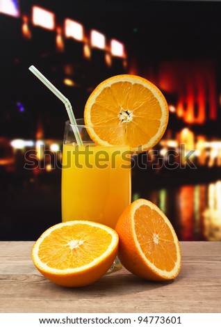 orange juice on the table night in a city cafe