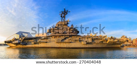 Exterior of Intrepid sea, air and space museum as seen from adjacent pier at sunset, side view - April 13, 2015, New York city, New York, USA