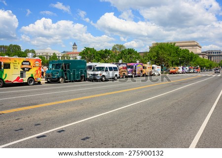 A row of colorful food trucks on a road in national mall - May 2, 2015, Washington DC, USA