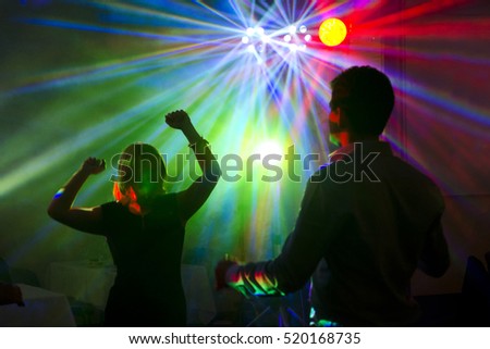 man an woman dancing together on party - night club photo