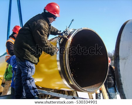 Safety at work. Welding and installation of the pipeline. Industrial weekdays welders and fitters.