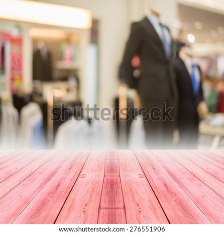 Perspective red wood over blur store of shopping mall blur background with bokeh.