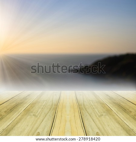 Perspective yellow wood over blur island with sea sunset background.