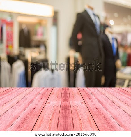 Perspective red wood over blur store of shopping mall blur background with bokeh.