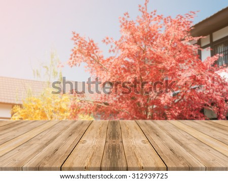 Wooden board empty table in front of blurred background. Perspective brown wood over blur beautiful resort and tree with bokeh - can be used for display or montage your products.