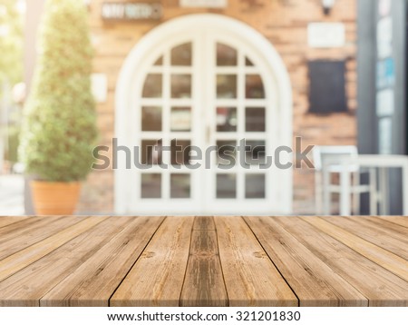Wooden board empty table in front of blurred background. Perspective brown wood over blur in coffee shop - can be used for display or montage your products.Mock up for display product.Vintage filter.
