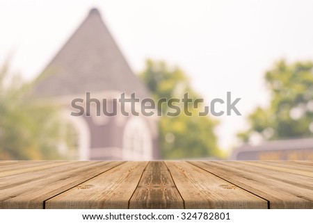 Wooden board empty table in front of blurred background. Perspective brown wood over blur building - can be used for display or montage your products.Mock up for display product.Vintage filter.