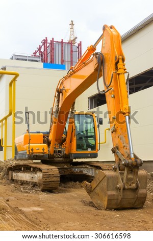 backhoe on the background of construction of the plant
