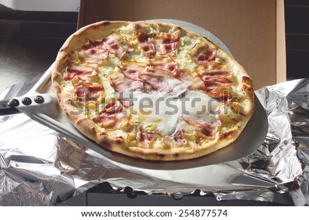 Freshly cooked  meat pizza with eggs pizza to delivery