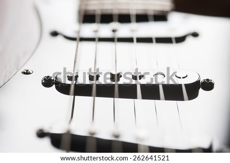closeup of pickups on an electric guitar