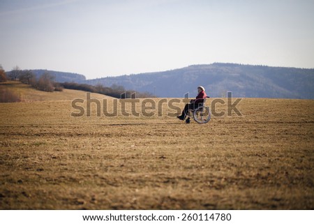Alone old woman on wheelchair