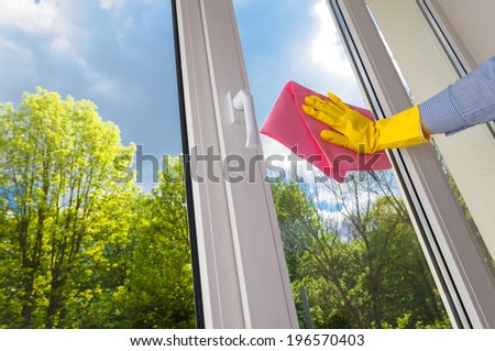 cleaning vinyl plastic window on a background blue sky