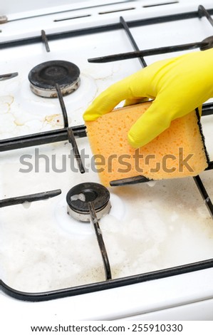 cleaning of dirty gas stove burners in kitchen room