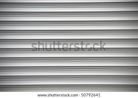 grey shutters over a shop doors
