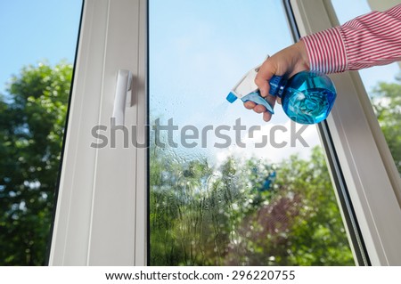 cleaning plastic vinyl window on a background blue sky