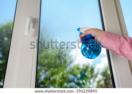 cleaning plastic vinyl window on a background blue sky