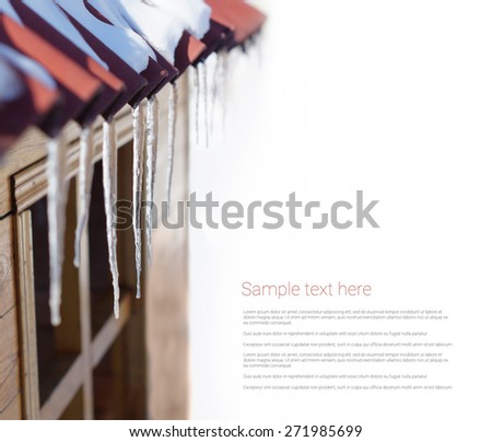Icicles hanging on the roof on white background, template