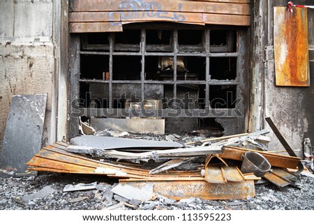 Burnt out shop with charred wall and furniture