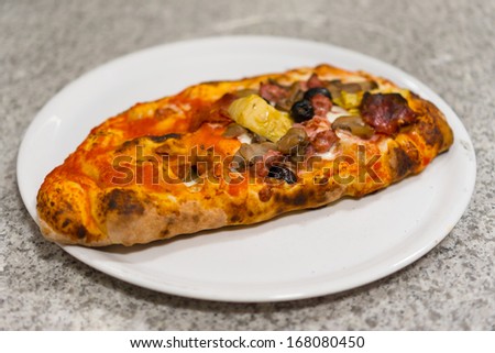Calzone - Stuffed Pizza with Tomato, Mozzarella Ham and mushrooms