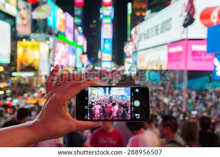 NEW YORK CITY - JUNE 13, 2015: Times Square from a smartphone, the busy tourist intersection of neon art and commerce of New York City